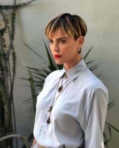 Actress Charlize Theron in a white blouse.