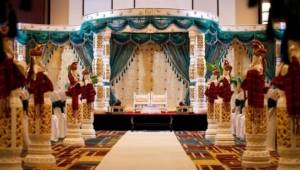 Banquet hall. At an Indian wedding, the bride and groom sit on a platform, on separate throne-like chairs.