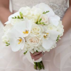 white roses and orchids in the bride&#39;s bouquet