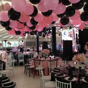 black and pink balloons in the banquet hall at a wedding