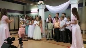 A children&#39;s choir performs a congratulation song at a wedding.