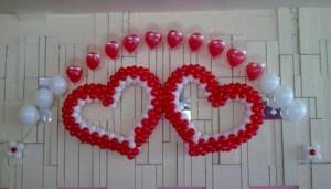 Two hearts on a wall made of white and red balls