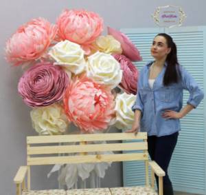 Photo zone made of life-size flowers made of corrugated paper