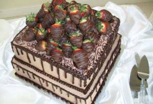 Fruit cake with chocolate covered strawberries