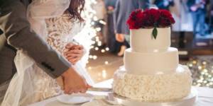 The classic wedding cake is served on a table.