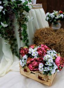 Boxes with handmade flower arrangements for a rustic wedding
