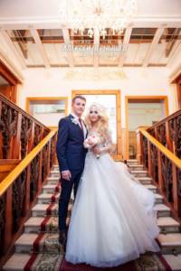 Newlyweds on the stairs in the Griboedovsky registry office photo