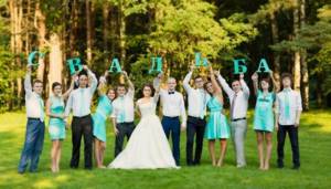 Newlyweds and loved ones take pictures with the letters of the word WEDDING