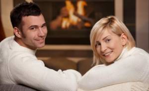 husband and wife by the fireplace