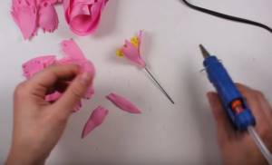 Start gluing the petals around the circle with overlapping