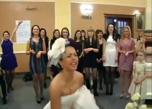 the bride throws a bouquet at her wedding