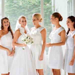 bride and wedding guests in white dresses