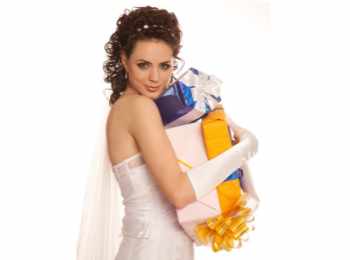 Bride with a satisfied expression on her face and a bunch of gifts in her hands