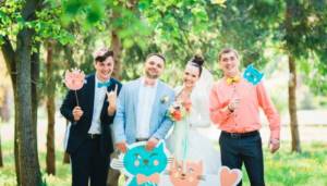 Newlyweds with friends and funny cardboard cats