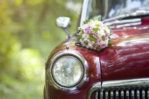 Decorating cars with fresh flowers at a wedding