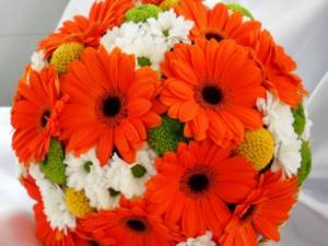 Orange chrysanthemums in a bouquet with other flowers