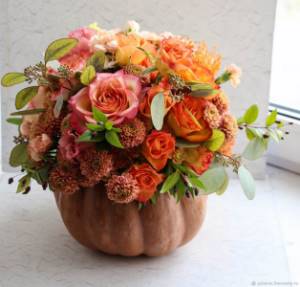 autumn composition of pumpkin with roses