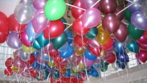 Multi-colored balloons hovering under the ceiling