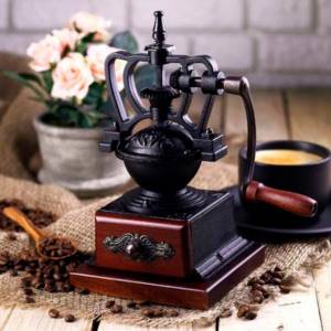 Manual coffee grinder made of cast iron and wood