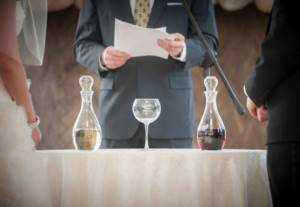 symbolic wedding ceremony - wine ceremony. The logic of the first variation of such a ceremony is simple: like sand in a sand ceremony, the newlyweds pour two different types of wine into one vessel. And then they drink the resulting drink in honor of creating their own family and offer the wine to all guests. 