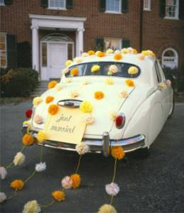 Decorating a wedding car with paper pompoms