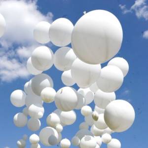 releasing balloons into the sky at a wedding