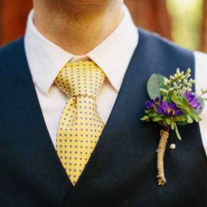 groom in a vest and boutonniere